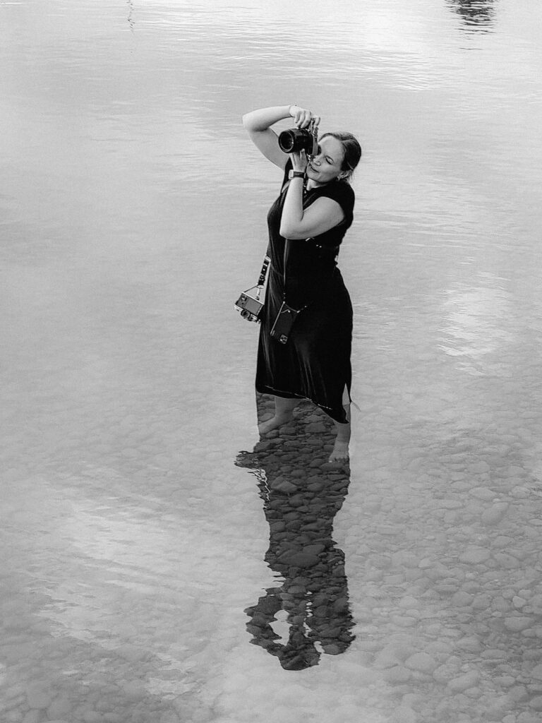 wedding photographer taking pictures standing in water | wedding photogrphy