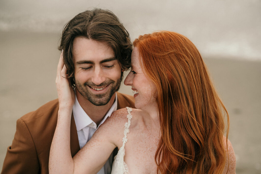 A woman smiling towards the man next to her.