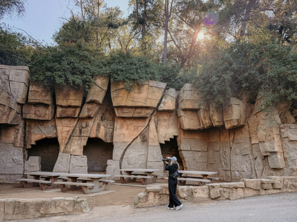 The Old Zoo LA at Griffith Park and a woman is standing in front taking photos.