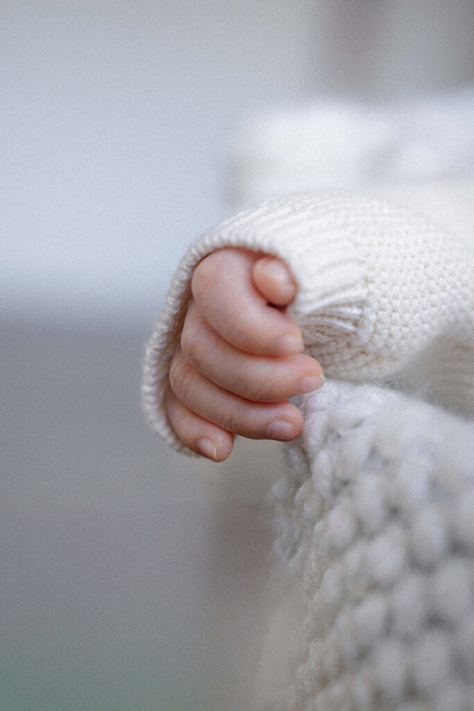 A baby's hand in focus. 
