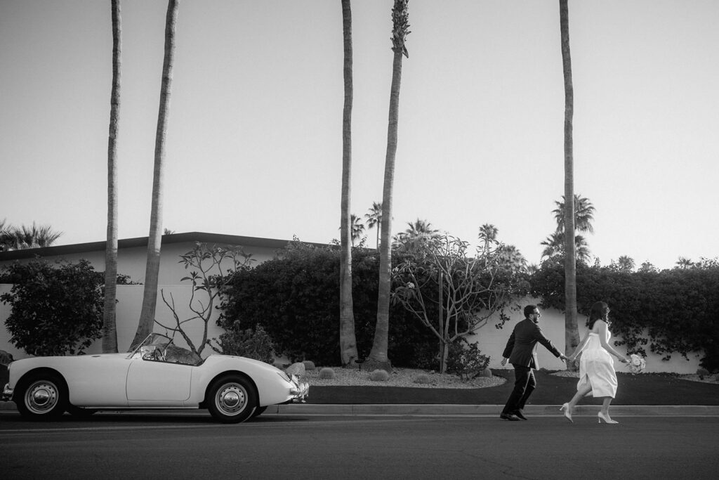 A couple running away from their car.